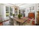 Bright dining room with hardwood floors, rustic table, and views of the landscaped yard at 2613 Forest Lake Ct, Wake Forest, NC 27587