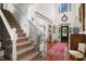 Welcoming foyer features hardwood floors, a grand staircase, and elegant decor at 2613 Forest Lake Ct, Wake Forest, NC 27587