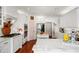 Bright kitchen features white cabinets, stainless steel appliances, marble countertops and hardwood floors at 2613 Forest Lake Ct, Wake Forest, NC 27587