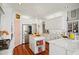 Bright kitchen features white cabinets, stainless steel appliances, marble countertops and a kitchen island at 2613 Forest Lake Ct, Wake Forest, NC 27587