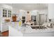 Bright kitchen features white cabinets, stainless steel appliances, marble countertops, and stylish sink fixtures at 2613 Forest Lake Ct, Wake Forest, NC 27587
