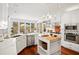 Bright kitchen features white cabinets, stainless steel appliances, hardwood floors and natural light at 2613 Forest Lake Ct, Wake Forest, NC 27587