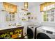 Clean laundry room features a wooden utility sink, front load machines, shelving and decor at 2613 Forest Lake Ct, Wake Forest, NC 27587