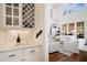 Bright living room featuring white couches, hardwood floors, and white cabinets with built in wine storage at 2613 Forest Lake Ct, Wake Forest, NC 27587