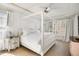 Bright main bedroom features a white canopy bed, bedside tables, and lots of natural light at 2613 Forest Lake Ct, Wake Forest, NC 27587