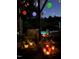 Cozy patio with lanterns and ambient lighting overlooking the shimmering pool at twilight at 2613 Forest Lake Ct, Wake Forest, NC 27587