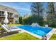 An inviting in-ground pool complemented by an elegant waterfall feature and lounge seating at 2613 Forest Lake Ct, Wake Forest, NC 27587