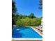 Tranquil pool surrounded by lush greenery and lounge chairs for relaxation at 2613 Forest Lake Ct, Wake Forest, NC 27587