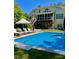 Lush backyard with inground pool, lounge chairs, and a covered porch at 2613 Forest Lake Ct, Wake Forest, NC 27587