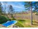 Backyard pool with adjacent lounge chairs and landscaped yard at 2613 Forest Lake Ct, Wake Forest, NC 27587