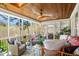 Screened-in porch with wood ceiling, fan, lots of natural light, and comfortable seating at 2613 Forest Lake Ct, Wake Forest, NC 27587