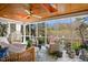 Bright sunroom with wood ceiling, ceiling fan, lots of natural light, and comfortable seating at 2613 Forest Lake Ct, Wake Forest, NC 27587