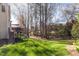 Lush backyard with mature trees, a deck, and plenty of space for outdoor activities at 2900 London Bell Dr, Raleigh, NC 27614