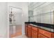 Cherry cabinets with black granite and mirrored shelves in the bar area at 2900 London Bell Dr, Raleigh, NC 27614