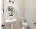 Half bathroom with pedestal sink, tile floor and decorative mirror at 2900 London Bell Dr, Raleigh, NC 27614