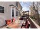 Spacious outdoor deck with red cushioned chairs, a table, and steps leading to a lower level at 2900 London Bell Dr, Raleigh, NC 27614