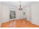 Bright dining room with hardwood floors, white wainscoting, and chandelier at 2900 London Bell Dr, Raleigh, NC 27614