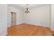 Formal dining room with hardwood floors, white wainscoting, and decorative chandelier at 2900 London Bell Dr, Raleigh, NC 27614
