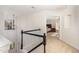 Upstairs hallway with carpet leading to a bedroom and view of the stairs at 2900 London Bell Dr, Raleigh, NC 27614