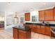 Kitchen featuring an island with granite countertops and dark wood cabinets at 2900 London Bell Dr, Raleigh, NC 27614