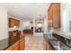 Spacious kitchen featuring an island with granite countertops, dark wood cabinets, and tile floors at 2900 London Bell Dr, Raleigh, NC 27614