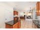 Open kitchen featuring an island with granite countertops and dark wood cabinets at 2900 London Bell Dr, Raleigh, NC 27614