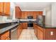 Kitchen with stainless steel appliances, granite counters, and dark wood cabinetry at 2900 London Bell Dr, Raleigh, NC 27614