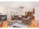 Open living room with fireplace, large brown couch, and access to the kitchen at 2900 London Bell Dr, Raleigh, NC 27614