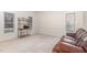 Neutral living room with a brown leather couch, beige walls, and several windows at 2900 London Bell Dr, Raleigh, NC 27614