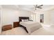 Main bedroom with large bed, carpet, tray ceiling and ceiling fan at 2900 London Bell Dr, Raleigh, NC 27614