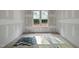 Bright bedroom featuring newly installed light-colored hardwood floors and two windows overlooking the landscape at 2957 Wexford Pond Way, Wake Forest, NC 27587
