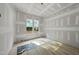 Bedroom showing unfinished drywall and newly installed light-colored hardwood floors and one window at 2957 Wexford Pond Way, Wake Forest, NC 27587