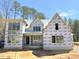 New construction shows the exterior of a beautiful two-story home with large windows and natural surroundings at 2957 Wexford Pond Way, Wake Forest, NC 27587