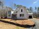 View of a new two-story home under construction, surrounded by trees and a construction site at 2957 Wexford Pond Way, Wake Forest, NC 27587