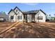 Rear exterior of a modern home with white siding, covered porches, and large windows at 2957 Wexford Pond Way, Wake Forest, NC 27587