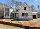 New two-story home under construction, featuring multiple windows and brick base at 2957 Wexford Pond Way, Wake Forest, NC 27587