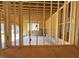 Unfinished interior showing exposed wood studs and a concrete slab floor at 2957 Wexford Pond Way, Wake Forest, NC 27587