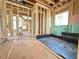 Unfinished interior with black lining in a corner and visible stair framing at 2957 Wexford Pond Way, Wake Forest, NC 27587