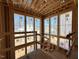 Unfinished interior with large window cluster and exposed wood framing at 2957 Wexford Pond Way, Wake Forest, NC 27587