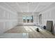 Bright living room featuring windows, door, hardwood floors, and drywall in progress at 2957 Wexford Pond Way, Wake Forest, NC 27587
