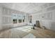 Sunlit living room featuring windows, hardwood floors, and drywall in progress at 2957 Wexford Pond Way, Wake Forest, NC 27587