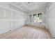 Light-filled living room with hardwood floors, drywall in progress and three large windows at 2957 Wexford Pond Way, Wake Forest, NC 27587