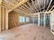 Bright living room featuring wood framing, windows, and a spacious open floor plan at 2957 Wexford Pond Way, Wake Forest, NC 27587