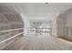 An unfinished open loft area with hardwood floors and many windows at 2957 Wexford Pond Way, Wake Forest, NC 27587