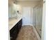 Bathroom featuring a double vanity, tiled floors, and a glass-enclosed shower at 30 Wheat Dr, Angier, NC 27501