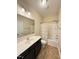Bright bathroom with a combination shower and tub, with a sink and wood cabinets at 30 Wheat Dr, Angier, NC 27501