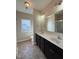 Bathroom with a double sink, large mirror, and wood cabinets at 30 Wheat Dr, Angier, NC 27501