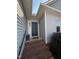 Inviting front entry with brick steps, a dark-colored door, and decorative sidelight at 30 Wheat Dr, Angier, NC 27501