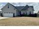 Charming one-story home featuring a two-car garage, landscaped yard and inviting entrance at 30 Wheat Dr, Angier, NC 27501
