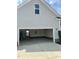 Spacious open garage featuring an access door to interior stairs and ample storage space at 30 Wheat Dr, Angier, NC 27501